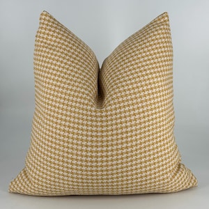 May include: A yellow and white gingham patterned throw pillow. The pillow is square and has a soft, textured fabric.