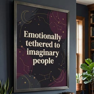 May include: Framed art print with the text "Emotionally tethered to imaginary people" in a white, stylized font. The background is black with purple accents, constellations, and crescent moons. The frame is a dark gray.