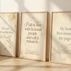 May include: Three framed art prints with inspirational quotes. The prints have a beige background with text in a brown font. The quotes are: "If it's not book-worthy love, I don't want it.", "I fall in love with fictional people and call it research.", and "My heart lives between the pages."