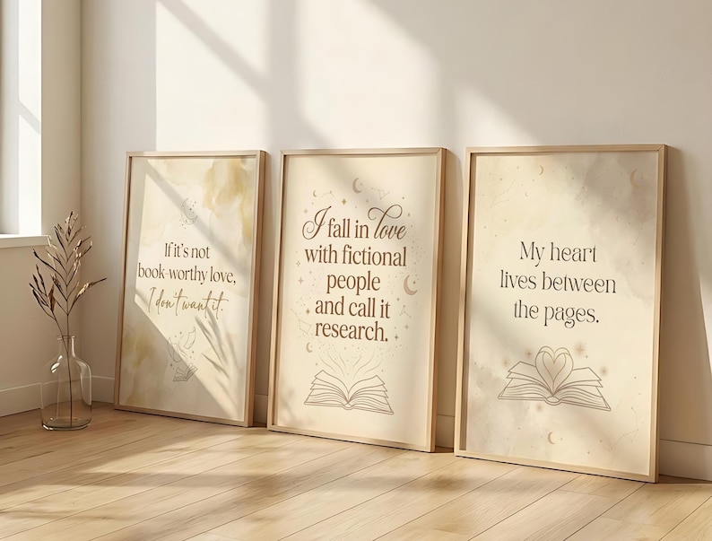 May include: Three framed art prints with inspirational quotes. The prints have a beige background with text in a brown font. The quotes are: "If it's not book-worthy love, I don't want it.", "I fall in love with fictional people and call it research.", and "My heart lives between the pages."