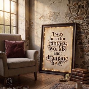 May include: A rectangular framed sign with a dark wood border and internal warm string lights. The off-white parchment-style background features the dark brown text: I was born for fantasy worlds and dramatic love, decorated with small crowns and stars.