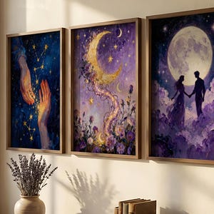 May include: Set of three framed art prints. The artwork features celestial and romantic themes, including hands reaching for stars, a crescent moon with floral accents, and a couple holding hands under a full moon. The color palette includes blues, purples, and gold.