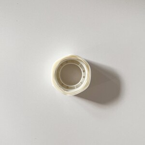 Top view of a single roll of transparent glue dots. Glue stickers are great for craft projects and tacking down dollhouse miniatures to keep them in place.