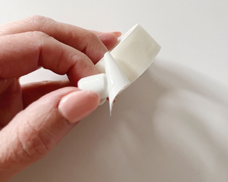 Detail of glue dot on bottom of miniature mug. Glue stickers are double-sided,  temporary hold and do not leave a residue when removed.