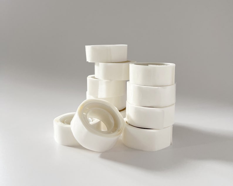 Rolls of transparent glue dots stacked on top of each other.