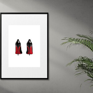 May include: A framed print of two black high-heeled shoes with red soles, viewed from the back.