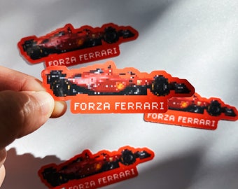 May include: Four red and black pixelated stickers of a Formula One race car with the text "Forza Ferrari" on each sticker.