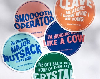 May include: Five round stickers with colorful backgrounds and white text. The stickers feature quotes from Formula 1 drivers, including "Leave me alone! I know what I am doing!" by Kimi Raikkonen, "I'm hanging here like a cow" by Nico Hulkenberg, and "I've got balls, but none of them are crystal" by Sebastian Vettel.