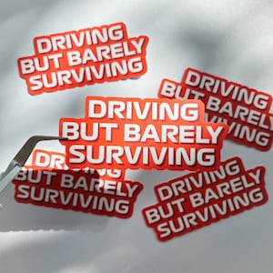 Formula 1 Funny Meme Waterproof Sticker - &quot;Driving But Barely Surviving&quot; - F1 Decal for Water Bottle, Cups, Laptop, Notebook