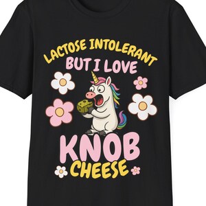 May include: Black t-shirt with a colorful graphic of a unicorn holding a cheese block. The text reads "LACTOSE INTOLERANT BUT I LOVE KNOB CHEESE" in yellow and pink, with flower accents.