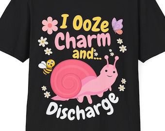 May include: Black t-shirt with a pink snail and the text "I Ooze Charm and... Discharge" in yellow and white lettering. The snail has a pink shell with a yellow center and a pink body. There are small yellow bees and pink flowers around the snail.
