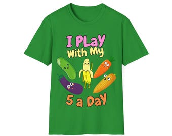 May include: A bright green short-sleeve t-shirt featuring a graphic of five cartoon vegetables and fruits with faces. The text reads I PLAY WITH MY 5 a Day. The illustration includes a cucumber, banana, carrot, eggplant, and corn on the cob.