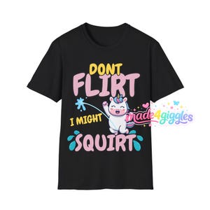 May include: Black t-shirt with a humorous unicorn graphic and the text "DON'T FLIRT I MIGHT SQUIRT". The design features a cartoon unicorn squirting water. The shirt has a crew neck and short sleeves.