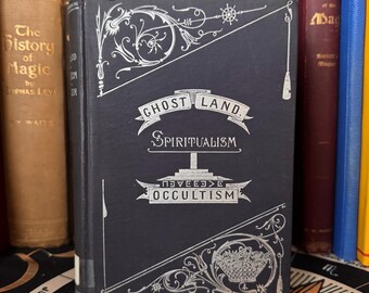 May include: A black hardcover book with silver lettering. The title is "Ghost Land. Spiritualism. Occultism."