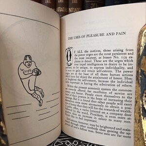 May include: A black and white illustration of a football player in a vintage style. The text "The Uses of Pleasure and Pain" is visible at the top of the page.