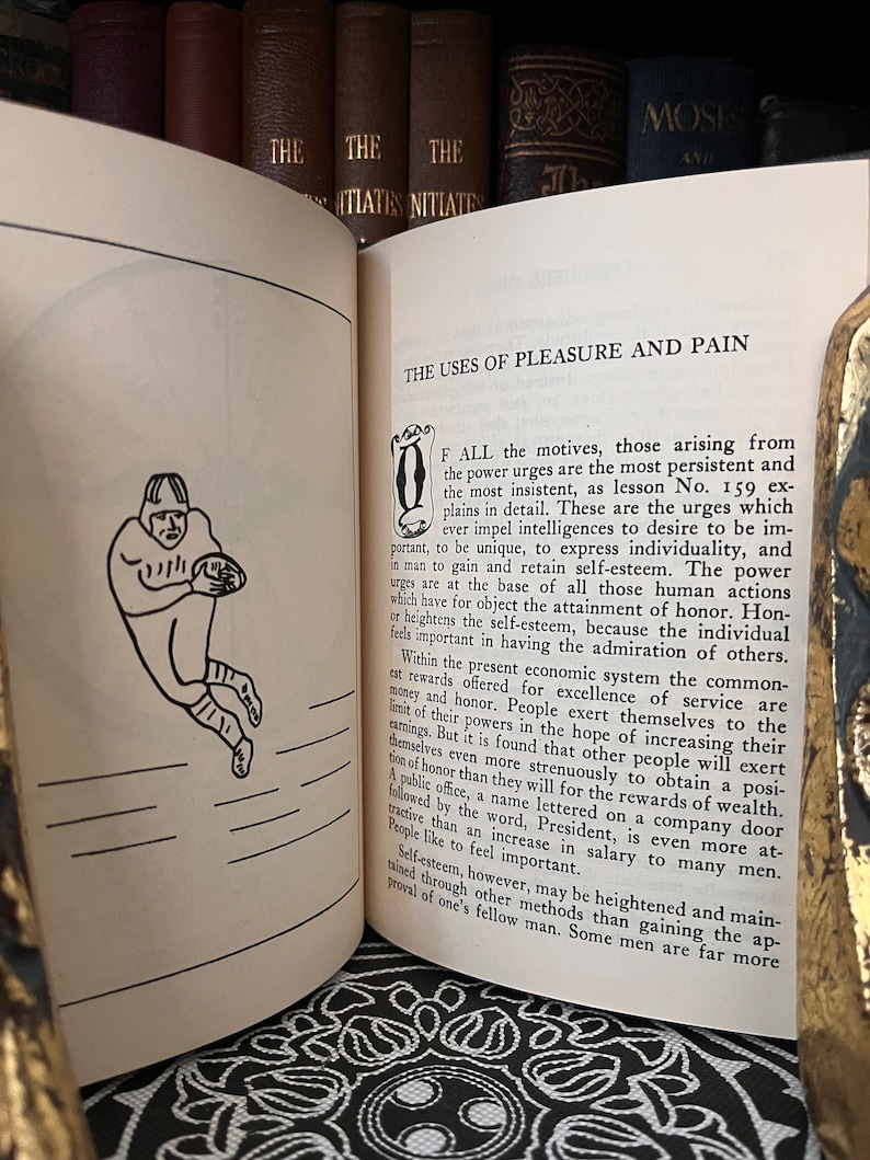 May include: A black and white illustration of a football player in a vintage style. The text "The Uses of Pleasure and Pain" is visible at the top of the page.