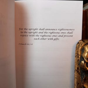 May include: Open book with text from I Enoch 81:7-8, in a serif font. The text reads: "For the upright shall announce righteousness to the upright and the righteous ones shall rejoice with the righteous ones and present each other with gifts."