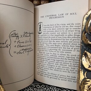 May include: A page from a book titled "The Universal Law of Soul Progression." The page is open to a chapter titled "1." The text discusses the concept of a universal law that applies to all things, including the soul. The text is written in a traditional serif font.