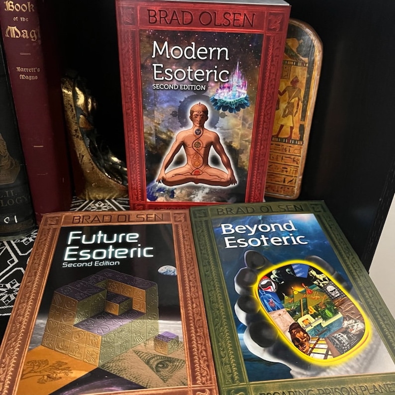 May include: Three books with red, green, and gold covers. The titles are "Modern Esoteric", "Future Esoteric", and "Beyond Esoteric". All three books are by Brad Olsen and are second editions.