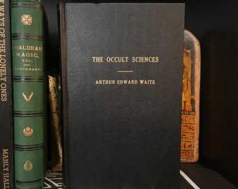 May include: A black hardcover book with gold lettering on the spine and front cover. The title is "The Occult Sciences" by Arthur Edward Waite.