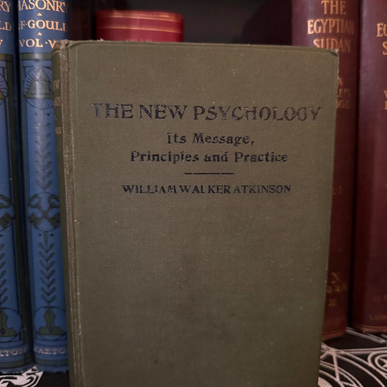 May include: A vintage green hardcover book titled "The New Psychology: Its Message, Principles and Practice" by William Walker Atkinson.