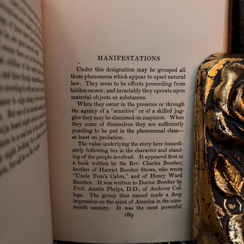 May include: A page from a book titled "Manifestations" discussing the impact of the book "Uncle Tom's Cabin" on American culture in the 19th century. The text describes the book's author, Harriet Beecher Stowe, and her brother, Charles Beecher, who wrote a book about the "sensitive" nature of the book's themes.