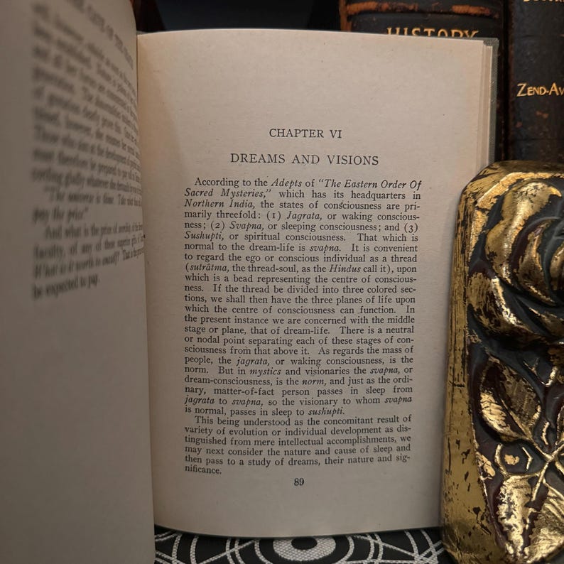 May include: A close-up of a book page with the title "Dreams and Visions" and text about the states of consciousness according to the Adepts of "The Eastern Order of Sacred Mysteries".