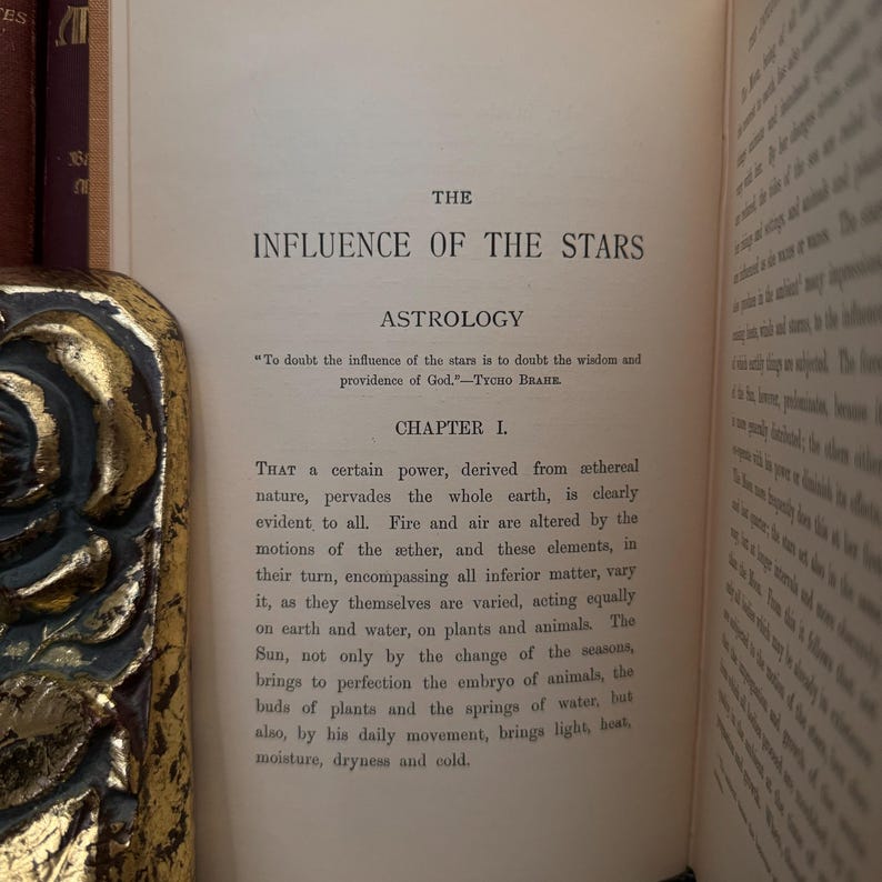 May include: A vintage book titled "The Influence of the Stars" with a chapter titled "Astrology". The text discusses the influence of the stars on the earth and its elements, including fire, air, water, and plants.
