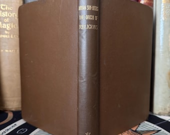 Może przedstawiać: Brązowa książka w skórzanej oprawie z pozłacanymi napisami na grzbiecie. Tytuł to "Aryan Sun-Myths: The Origin of Religions".
