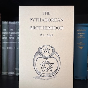 May include: A brown book titled "The Pythagorean Brotherhood" by R.C. Abel. The cover features a black and white illustration of a ring with a five-pointed star.