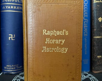 May include: A brown leather-bound book with gold lettering on the spine that reads "Raphael's Horary Astrology".