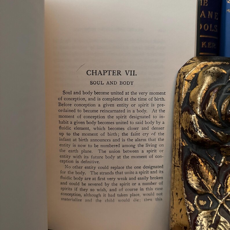 May include: A close-up of a page from a book titled "Soul and Body." The text discusses the union of soul and body at the moment of conception and birth. The book is open to Chapter VII.