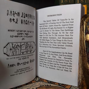 May include: An open book displaying text and illustrations. The left page is covered in hieroglyphic-style symbols and drawings. The right page has the title "INTRODUCTION" and detailed text about a sacred tablet.