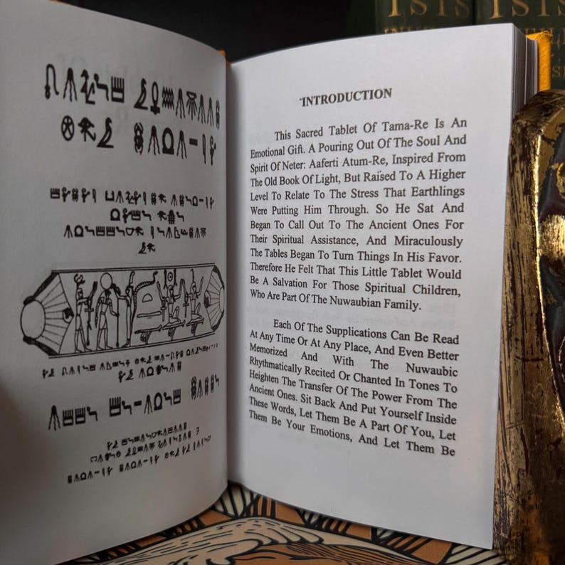 May include: An open book displaying text and illustrations. The left page is covered in hieroglyphic-style symbols and drawings. The right page has the title "INTRODUCTION" and detailed text about a sacred tablet.
