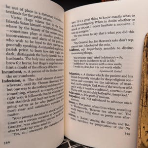 May include: A page from a book with text about the meaning of the word "indifferent". The text is in black and white and the page number is 145.