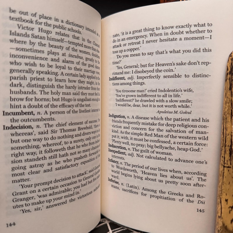 May include: A page from a book with text about the meaning of the word "indifferent". The text is in black and white and the page number is 145.