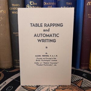 May include: A vintage book cover with a cream background and black text. The title is "Table Rapping and Automatic Writing" by Alexr. Verner, F.A.I.P. The book is about the British Psychological Institute and the author's work on "Medical Hypnotism" and "Practical Psychometry".