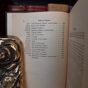 May include: A close-up of a book's table of contents page, showing chapter titles and page numbers. The book is titled "The Diamond Heart" and includes chapters like "Faith and Works", "Crossing Jordan", and "The Soul's Guerdon".