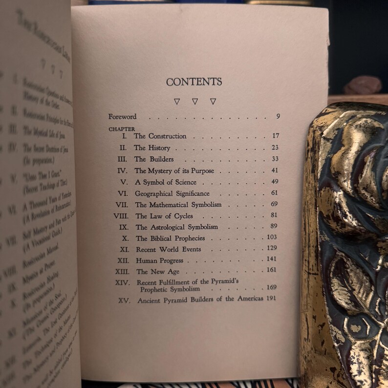 May include: A book titled "The Great Pyramid" with a table of contents listing chapters on the construction, history, builders, mystery of its purpose, and more. The book is printed on white paper with black text.