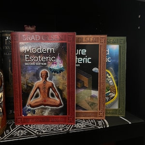 May include: Four books with red, brown, and green covers. The books are titled "Modern Esoteric", "Pure Esoteric", "The Hidden Planet", and "Modern Esoteric: Beyond Our Senses".