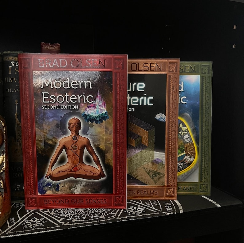 May include: Four books with red, brown, and green covers. The books are titled "Modern Esoteric", "Pure Esoteric", "The Hidden Planet", and "Modern Esoteric: Beyond Our Senses".