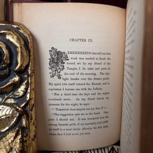 May include: A page from a vintage book with the title "Chapter III. Remembering" and text about a friend and the passage of time. The text is printed in black ink on cream-colored paper.