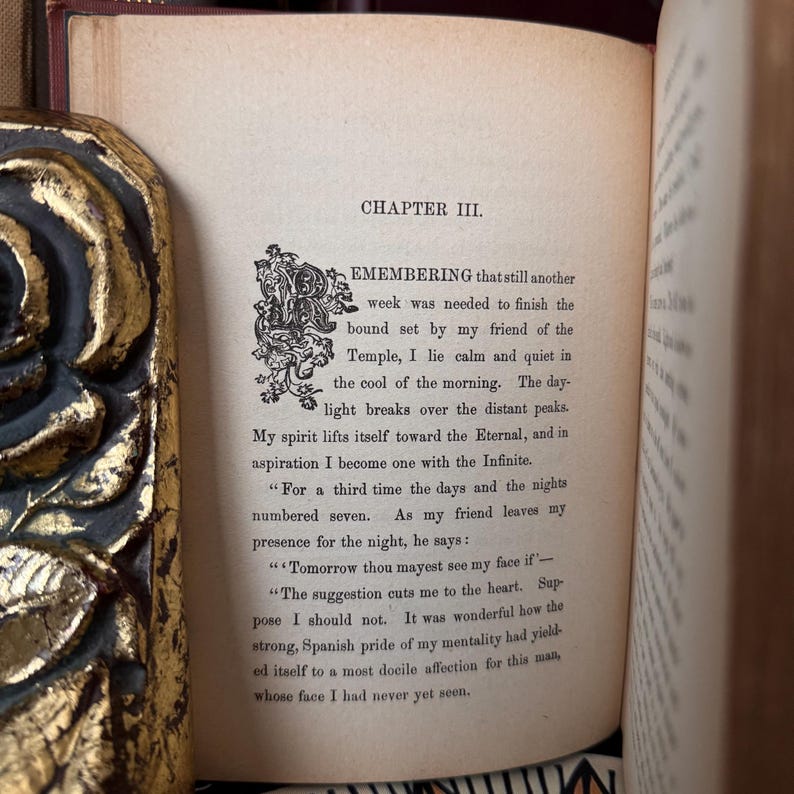 May include: A page from a vintage book with the title "Chapter III. Remembering" and text about a friend and the passage of time. The text is printed in black ink on cream-colored paper.