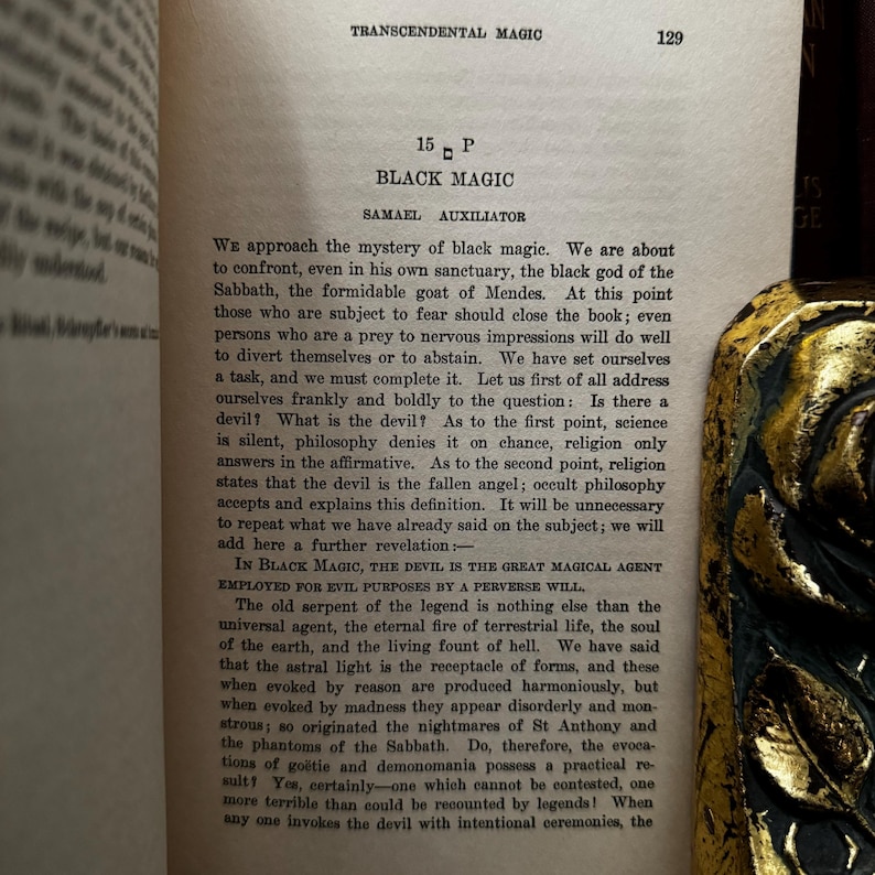 May include: A page from a book titled "Transcendental Magic" with the chapter title "Black Magic" and the subtitle "Samael Auxiliator". The text discusses the nature of the devil and black magic.