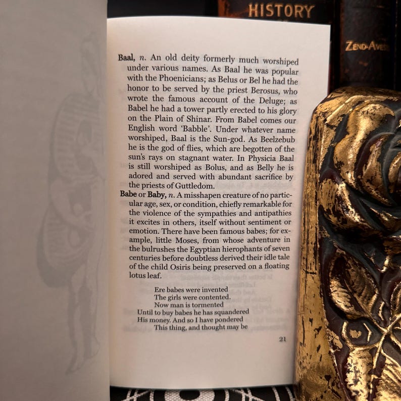 May include: A page from a book titled "History" with text about the deity Baal and the word "Babe or Baby". The text describes the deity Baal as a sun god and the word "Babe or Baby" as a misshapen creature. The text also includes a poem about babies.