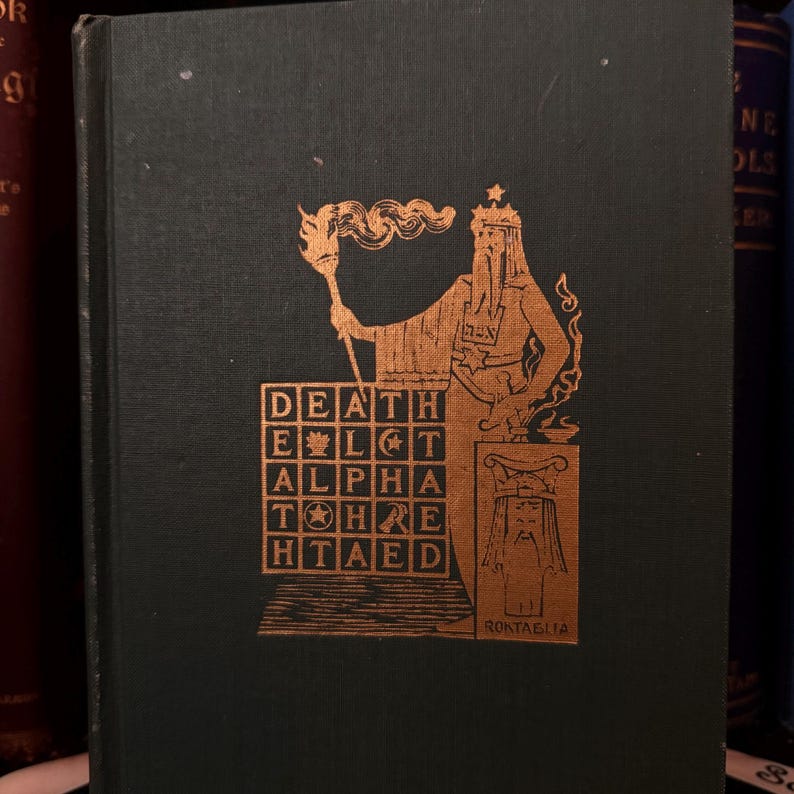 May include: A vintage book cover with a gold-colored illustration of a figure holding a torch and a shield. The figure is standing on a pedestal with a square grid containing the words "DEATH", "ELGT", "ALPHA", "TOHRE", and "HTAED". The text "RONTAGLIA" is at the bottom of the illustration.