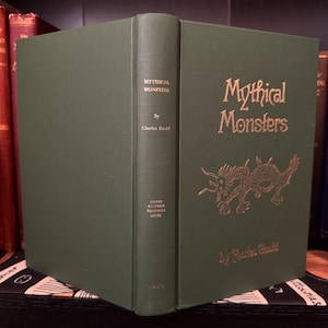May include: A green hardback book titled "Mythical Monsters" by Charles Gould. The cover features a gold illustration of a dragon.