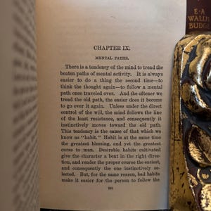 May include: A page from a book titled "Mental Paths" by E-A Wallis Budge. The text discusses the tendency of the mind to follow familiar paths and the concept of habit as both a blessing and a curse.