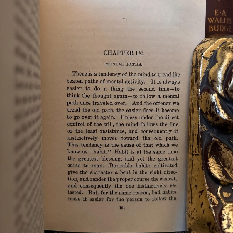 May include: A page from a book titled "Mental Paths" by E-A Wallis Budge. The text discusses the tendency of the mind to follow familiar paths and the concept of habit as both a blessing and a curse.
