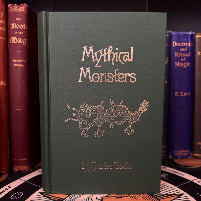 May include: A green hardback book titled "Mythical Monsters" by Charles Gould. The cover features a gold illustration of a dragon.
